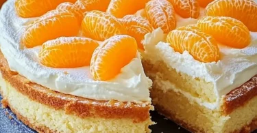 Mandarinen-Schmand-Kuchen auf einem Teller mit frischen Mandarinen