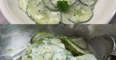 Frischer Gurkensalat mit Kräutern und Dressing auf einem Teller.