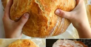 Frisch gebackenes Hausbrot auf einem Holzbrett, bereit zum Servieren.