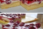 Köstliche Kirschtorte mit Sauerrahm auf einem Teller, dekoriert mit Kirschen.