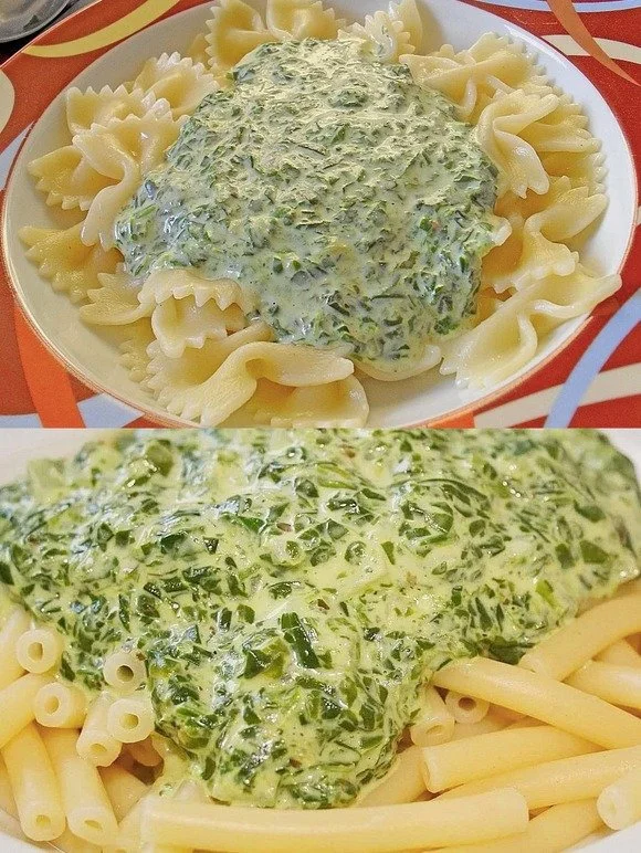 Nudeln in Spinatsauce mit Frischkäse serviert auf einem Teller