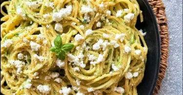 Pasta mit leckerer Zucchini-Sauce auf einem Teller serviert.