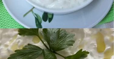 Griechischer Gurken-Joghurt-Dip in einer Schüssel serviert mit frischen Kräutern.