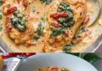 Hähnchen in cremiger Spinat-Parmesan-Soße serviert auf einem Teller