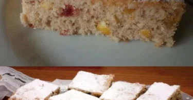Kuchen mit Haselnüssen und Trockenfrüchten auf einem Teller serviert