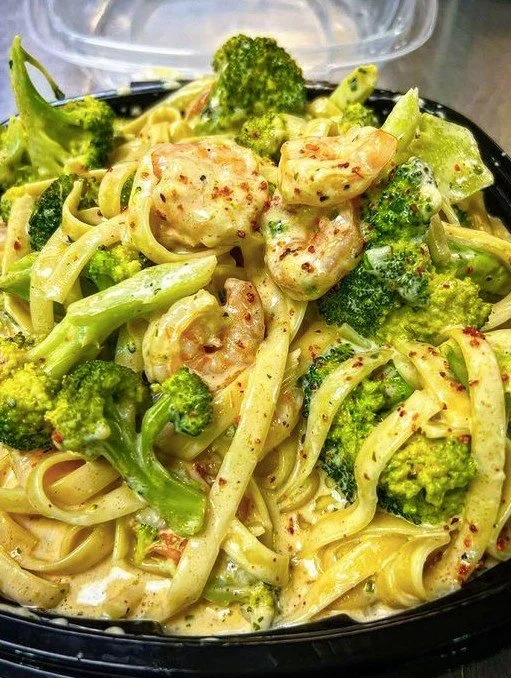 Tagliatelle with broccoli and shrimp in creamy sauce