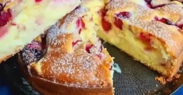 Kirschkuchen mit Vanillepudding auf einem Teller serviert